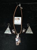 SWAROVSKI; A SILVER AND COLOURED GLASS NECKLACE AND EARRING SET; MODERNIST FORM; THE NECKLACE ON A