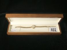 A BOXED 9 CARAT GOLD TISSOT LADIES WATCH; MARKED 375; LONDON; POSSIBLY 1955; TEXTURED LINKS W/O