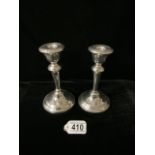 A PAIR OF STERLING SILVER CANDLESTICKS; MAKERS MARK RUBBED; BIRMINGHAM 1931; CIRCULAR FORM; HEIGHT