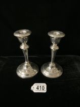 A PAIR OF STERLING SILVER CANDLESTICKS; MAKERS MARK RUBBED; BIRMINGHAM 1931; CIRCULAR FORM; HEIGHT