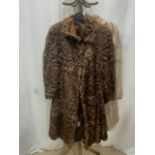 A MID-LENGTH BEIGE FUR COAT FULLY-LINED UK SIZE 14 WITH A DARK BROWN FUR CAPE