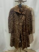 A MID-LENGTH BEIGE FUR COAT FULLY-LINED UK SIZE 14 WITH A DARK BROWN FUR CAPE