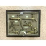 CASED ANTIQUE BRASS BOTTLING TAPS 57 X 45CM