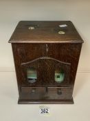 A VINTAGE WOODEN COIN OPERATED CIGARETTE DISPENSER, RECTANGULAR FORM, COIN SLOTS AND PRICE PANELS TO
