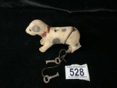 A VINTAGE MECHANICAL WIND UP DOG TOY MODELLED AS A TERRIER; LENGTH 9.5CM