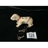 A VINTAGE MECHANICAL WIND UP DOG TOY MODELLED AS A TERRIER; LENGTH 9.5CM