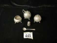 A MIDDLE EASTERN WHITE METAL THREE PIECE CONDIMENT SET; GLOBULAR FORM; EMBOSSED WITH FLORAL SCROLLS;