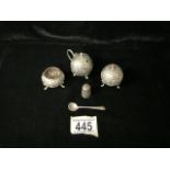 A MIDDLE EASTERN WHITE METAL THREE PIECE CONDIMENT SET; GLOBULAR FORM; EMBOSSED WITH FLORAL SCROLLS;