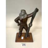 A VINTAGE NOVELTY TABLE LIGHTER MODELLED AS AN AIRMAN WITH PROPELLOR, ON WOODEN PLINTH; HEIGHT 27CM