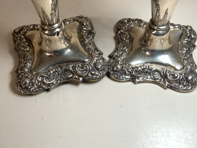 A PAIR OF STERLING SILVER DWARF CANDLESTICKS, BY WALKER & HALL; BIRMINGHAM 1911; SHAPED SQUARE FORM, - Image 2 of 2