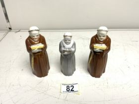 THREE ROYAL WORCESTER CANDLE SNUFFERS IN THE FORM OF MONKS; LARGEST 33CM