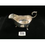 A STERLING SILVER SAUCEBOAT BY MAPPIN & WEBB; BIRMINGHAM 1911; REEDED BORDER, SCROLL HANDLE, ON