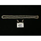 A 9 CARAT GOLD AND PEARL JEWELLERY SET; NECKLACE; LONDON 1984; ROPE TWIST CLASP AND CLIP ON