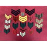 A QUANTITY OF MILITARY CLOTH TUNIC RANK CHEVRONS, VARIOUS COLOURS AND SIZES