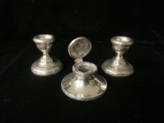 A PAIR OF STERLING SILVER DWARF CANDLESTICKS; BIRMINGHAM 1972 AND A SMALL STERLING SILVER CAPSTAN