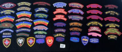 A QUANTITY OF CANADIAN MILITARY CLOTH BADGES AND SHOULDER TITLES INCLUDING ROYAL ELECTRICAL