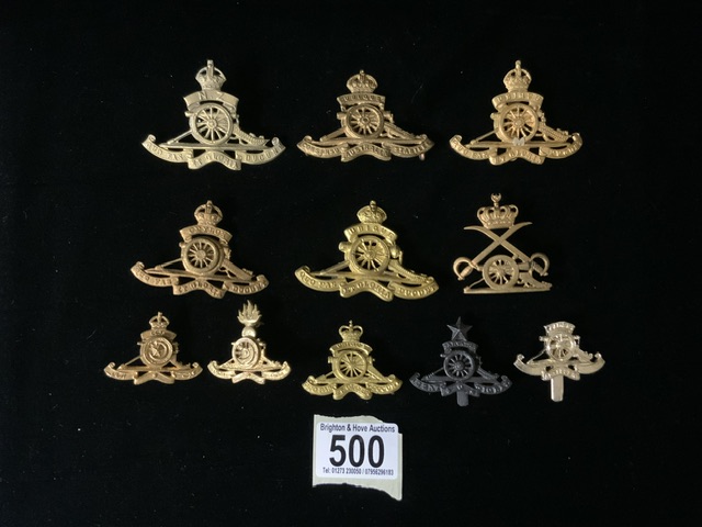 A QUANTITY OF METAL MILITARY CAP BADGES