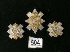 THREE METAL MILITARY CAP BADGES COMPRISING; 42ND BATTALION, THE BLACK WATCH AND TWO HIGHLAND LIGHT