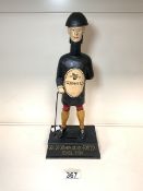 A CAST IRON GUINNESS MONEY BOX, MODELLED AS A MALE FIGURE, ON RECTANGULAR BASE 'GOOD FOR HIM GOOD