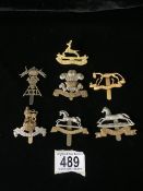 A QUANTITY OF METAL MILITARY CAP BADGES INCLUDING ROYAL CANADIAN DRAGOONS, KINGS OWN HUSSARS, WEST