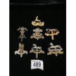 A QUANTITY OF METAL MILITARY CAP BADGES INCLUDING ROYAL CANADIAN DRAGOONS, KINGS OWN HUSSARS, WEST