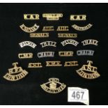 A QUANTITY OF METAL MILITARY CAP BADGES AND SHOULDER TITLES INCLUDING; R. SUSSEX, SOMALIALAND