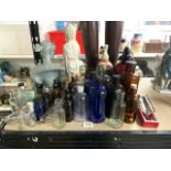 LARGE QUANTITY OF GLASS MEDICINE BOTTLES, BLUE, BROWN AND CLEAR WITH TWO SODA SYPHONS AND MORE