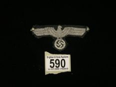 A WWII MILITARY GERMAN ARMY CLOTH BADGE, EAGLE EMBROIDERED IN SILVER GREY THREAD; LENGTH 8CM