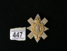 A MILITARY METAL CAP BADGE, POSSIBLY THE BLACK WATCH (ROYAL HIGHLANDERS); LENGTH 7.5CM