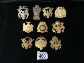 A QUANTITY OF METAL MILITARY CAP BADGES; MOSTLY U.S