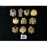 A QUANTITY OF METAL MILITARY CAP BADGES; MOSTLY U.S