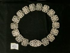 AN ANTIQUE ELECTROPLATED BELT; EACH SECTION OF SHAPED RECTANGULAR FORM; OPEN WORK FLORAL DECORATION