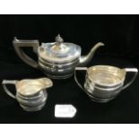 HALLMARKED SILVER OVAL THREE PIECE TEA SERVICE WITH REEDED BORDERS AND FRUIT WOOD HANDLE DATED