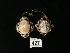 TWO LARGE VINTAGE CAMEO BROOCHES; ONE DEPICTING A FACE IN PROFILE; THE OTHER DEPICTING A CLASSICAL