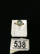 A VINTAGE 9 CARAT GOLD AND AQUAMARINE DRESS RING; STAMPED '9CT', STONE OF OVAL FORM, IN A ROPE TWIST