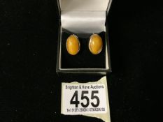 A PAIR OF VINTAGE 9 CARAT GOLD MOUNTED POSSIBLY AGATE OR AMBER SCREW ON EARRINGS; LONDON 1977;