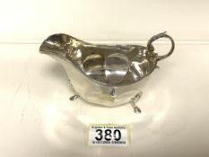 A STERLING SILVER SAUCEBOAT BY ADIE BROS; BIRMINGHAM 1927; REEDED BORDER, PANELLED BODY, SCROLL