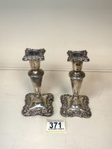 A PAIR OF STERLING SILVER DWARF CANDLESTICKS, BY WALKER & HALL; BIRMINGHAM 1911; SHAPED SQUARE FORM,