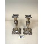 A PAIR OF STERLING SILVER DWARF CANDLESTICKS, BY WALKER & HALL; BIRMINGHAM 1911; SHAPED SQUARE FORM,