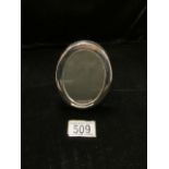A STERLING SILVER PHOTOGRAPH FRAME; SHEFFIELD 1990; ENGRAVED CONCORDE; OVAL FORM; HEIGHT 11.5CM