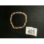 A VINTAGE BRACELET,;THE CLASP STAMPED 375; OVAL AND CIRCULAR LINKS SET WITH STONES