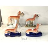 FOUR 19TH CENTURY HUNTING DOG / WHIPPET / GREYHOUND FIGURINES, TWO HOLDING A CATCH AND A PAIR IN A