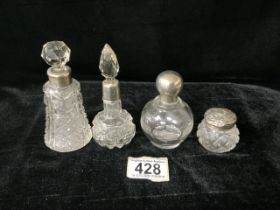 FOUR ANTIQUE GLASS AND SILVER SCENT BOTTLES / VANITY JAR, COMPRISING; A CUT GLASS EXAMPLE; LONDON