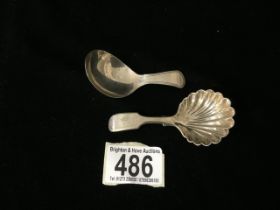 TWO CADDY SPOONS; ONE WITH SHELL PATTERN; BY WALKER & HALL; TOTAL SILVER WEIGHT; 28 GRAMS