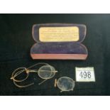 A VINTAGE BOXED PAIR OF GOLD GLASSES; STAMPED 10 CT AND ANOTHER GOLD MOUNTED LENS