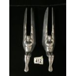 A PAIR OF VINTAGE CAST ALUMINIUM HOOD ORNAMENTS / MASCOTS; MODELLED AS WINGED SEATED FIGURES; LENGTH