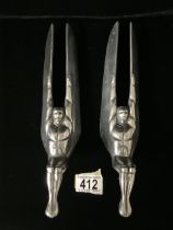 A PAIR OF VINTAGE CAST ALUMINIUM HOOD ORNAMENTS / MASCOTS; MODELLED AS WINGED SEATED FIGURES; LENGTH
