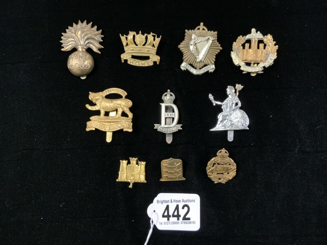 A QUANTITY OF MILITARY METAL CAP BADGES INCLUDING; TANK CORPS, ESSEX REGT. DRAGOONS AND OTHERS