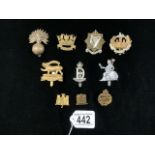 A QUANTITY OF MILITARY METAL CAP BADGES INCLUDING; TANK CORPS, ESSEX REGT. DRAGOONS AND OTHERS
