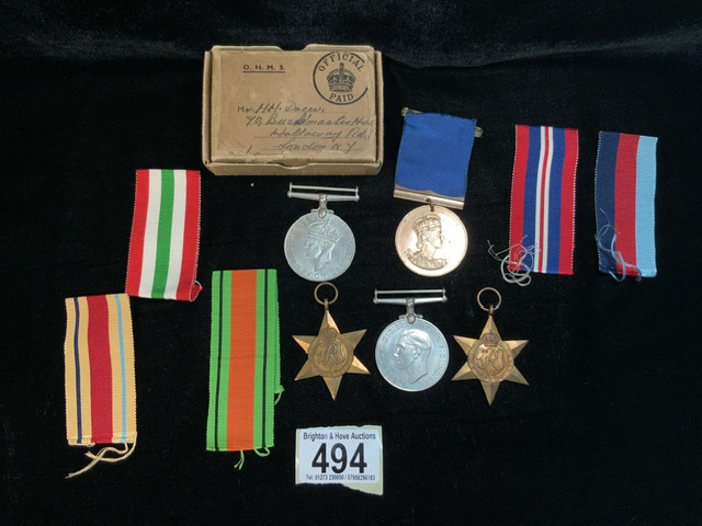 A COLLECTION OF MILITARY MEDALS AND RIBBONS INCLUDING; THE DEFENCE MEDAL, A WWII MEDAL, A 1953